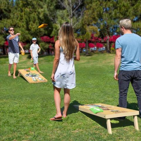 people playing cornhole game